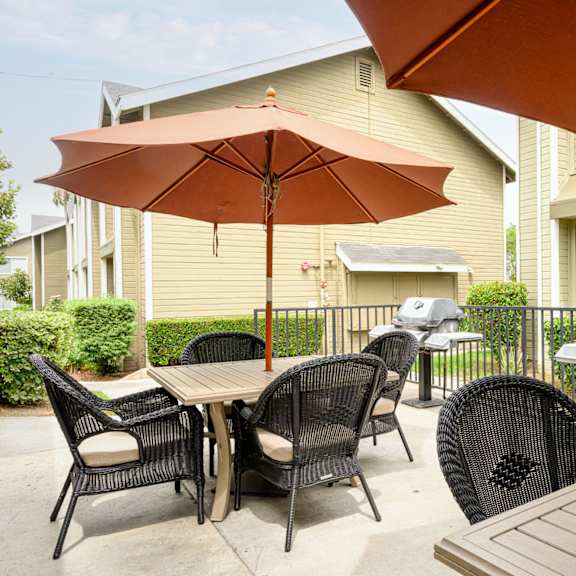 the reserve at bucklin hill patio with tables and chairs and a grill at sagewood gardens senior apartments, hacienda heights, ca