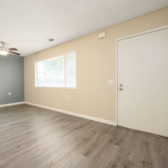 a bedroom with hardwood floors and a ceiling fan at sagewood gardens senior apartments, hacienda heights, ca