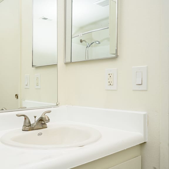 a bathroom with a sink and a mirror at sagewood gardens senior apartments, hacienda heights, 91745