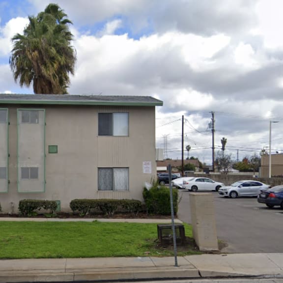 a building with a palm tree in front of it.