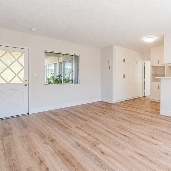 a room with wooden flooring and white walls.