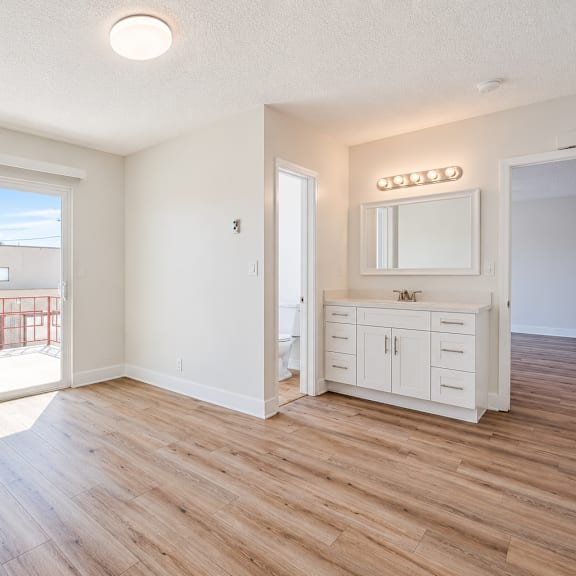 a room with a sliding glass door leading to a balcony.