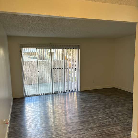 a room with a window covered in blinds.