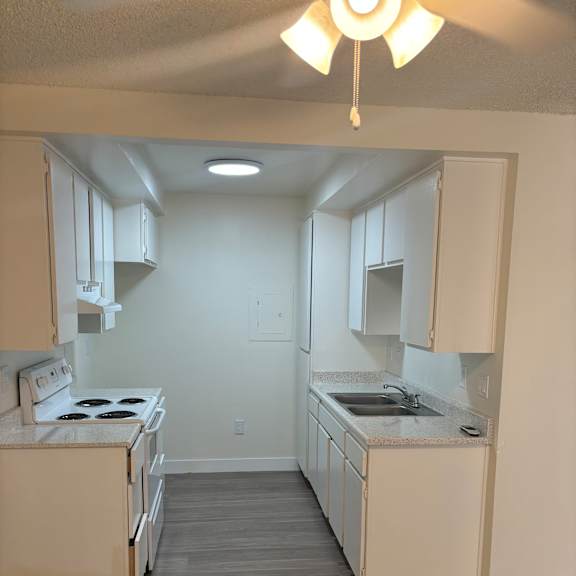 a white microwave oven is on top of a white counter.