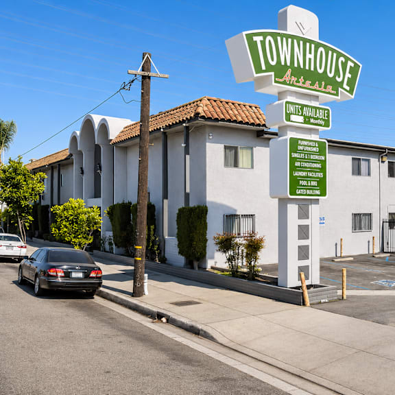 a sign for townhouse in brea, california is shown in front of a building.