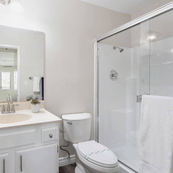 a white bathroom with a shower sink and toilet at huntington terrace north senior, huntington beach, 92648