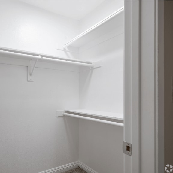 a walk in closet with a white wall and a white door at huntington terrace north senior, huntington beach, 92648