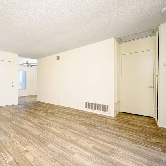 a bedroom with hardwood floors and white walls at villa hemet, hemet