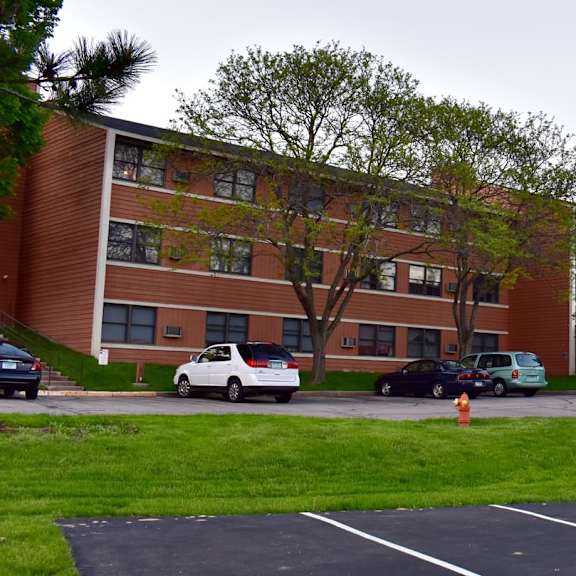 a parking lot in front of a brick building.