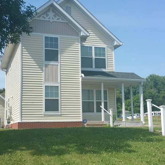 a house with a grey siding and a white trim.