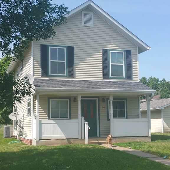 a house with a dog standing in front.