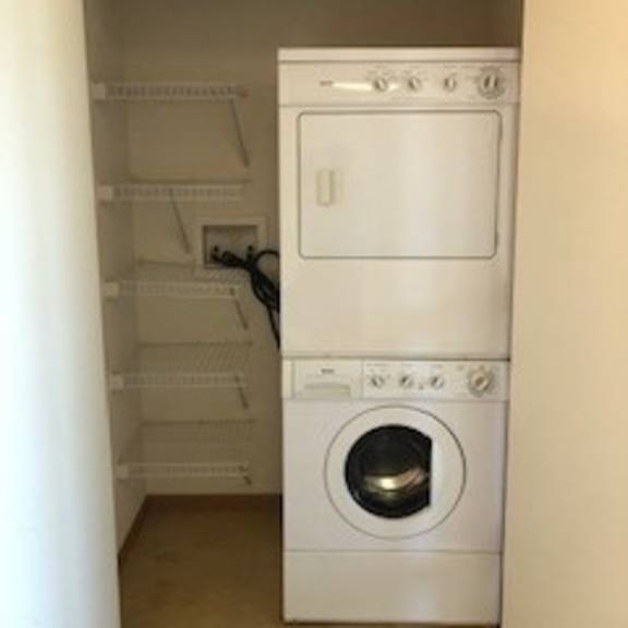 a white oven and washing machine in a small room.