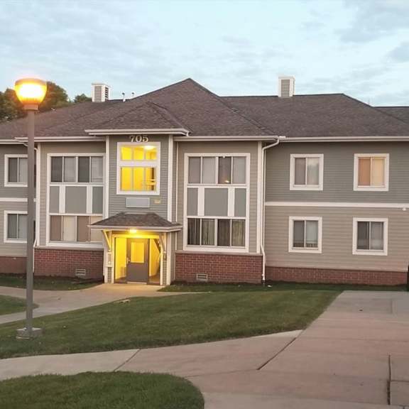 a building with a yellow light on the front door.