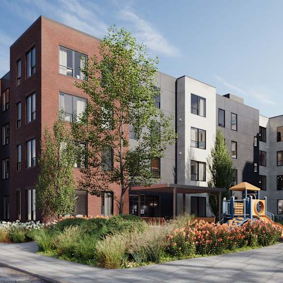a modern apartment complex with a playground in the foreground.