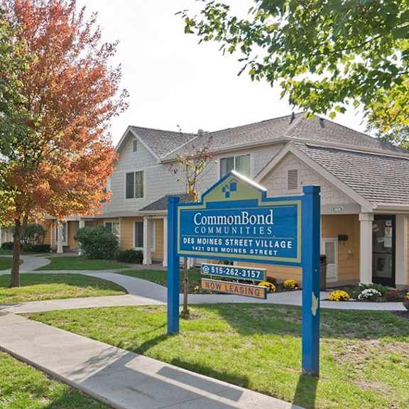 a sign for commonbond communities is in front of a house.