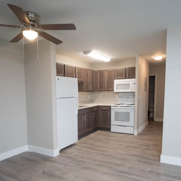a kitchen with a white fridge and a white oven.
