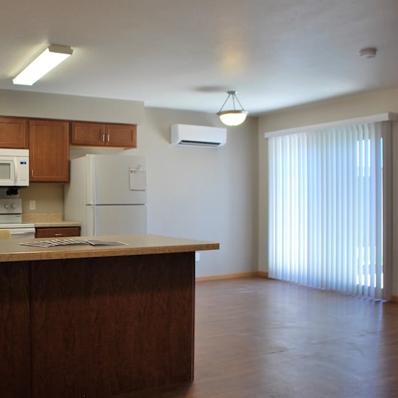 a kitchen with wooden cabinets and a white refrigerator.