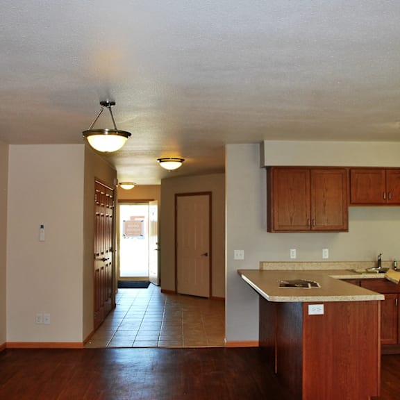 a kitchen with wooden cabinets and a white dishwasher.