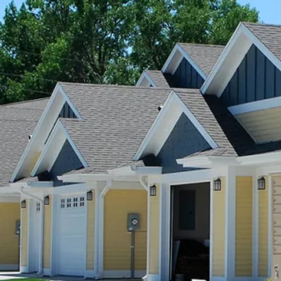 a row of houses with a car parked in front of them.