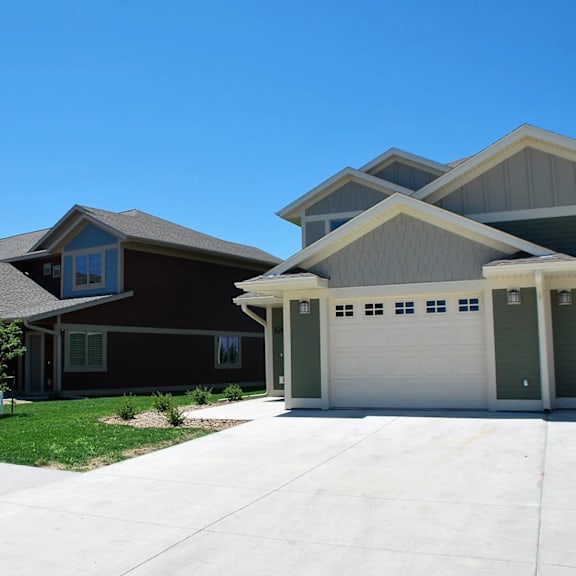 a row of houses with garages and driveways.