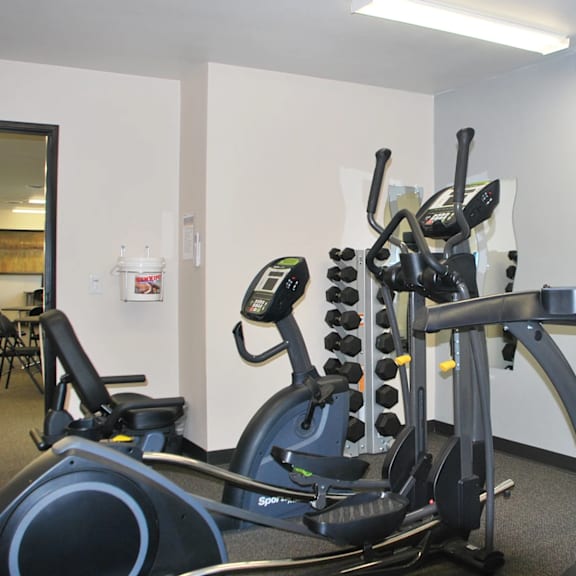 a gym with a stationary bike and a treadmill.