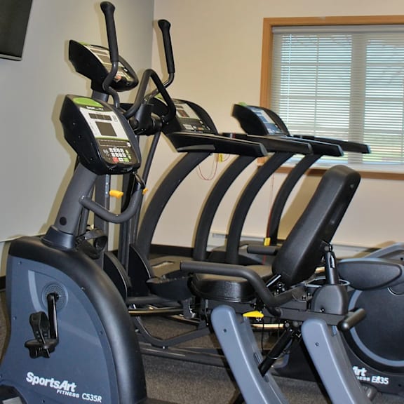 a sportsart exercise bike is in a room with a window.