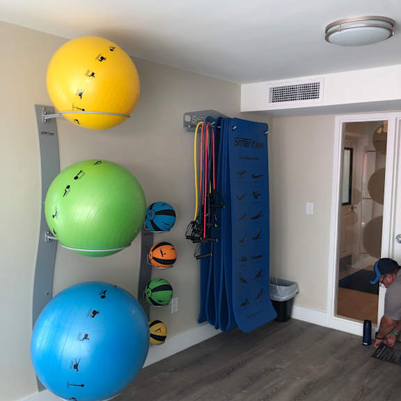 a room with a white wall and a blue ball on the floor.