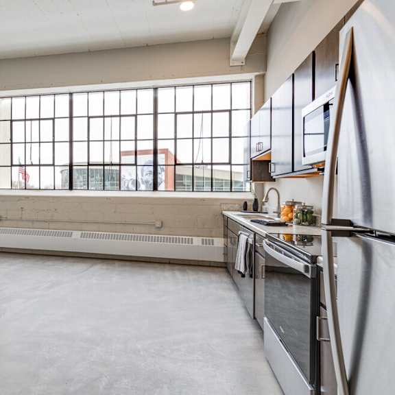 a kitchen with a window overlooking a building.