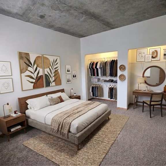 a bedroom with a large bed and a clothing rack.