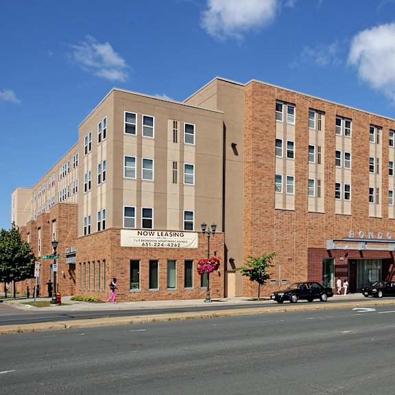 a large brick building with a sign that says "now lasagna" on it.