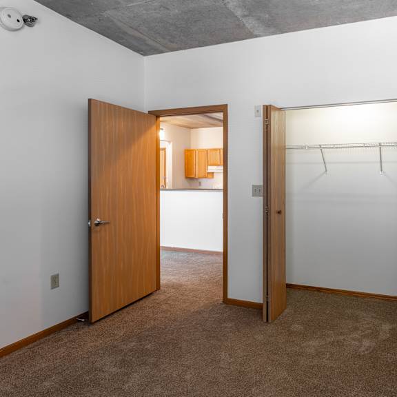 a room with a brown door and a white wall.