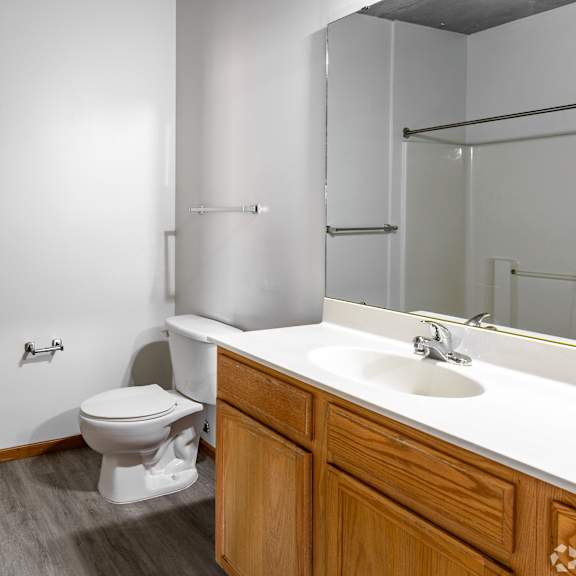 a white toilet sits in a bathroom next to a sink.