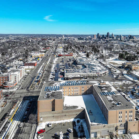 a cityscape with buildings and roads covered in snow.