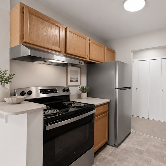 a kitchen with a black stove top oven and a silver refrigerator.