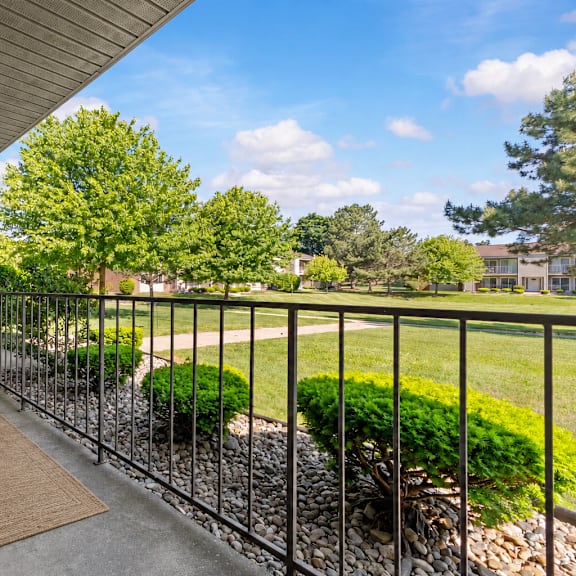 a patio with a chair and table is shown.