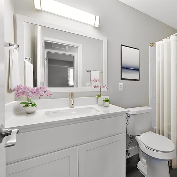 a bathroom with a toilet sink and a shower at sunnymede apartments - troy, mi, michigan