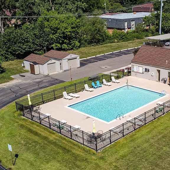 a swimming pool in the backyard of a house at sunnymede apartments - troy, mi, troy, 48084