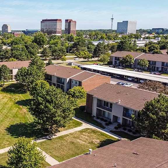 an aerial view of a neighborhood with houses and a field at sunnymede apartments - troy, mi, michigan
