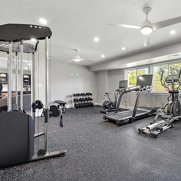 a home gym with exercise equipment and a window at sunnymede apartments - troy, mi, troy, michigan