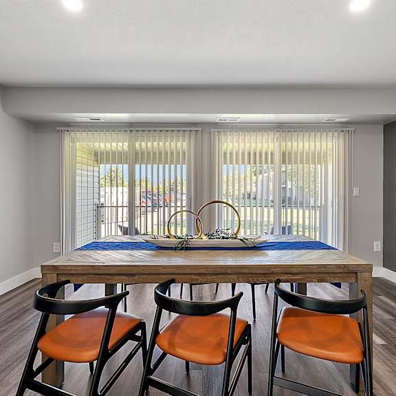 a dining room with a wooden table and four chairs at sunnymede apartments - troy, mi, troy, michigan