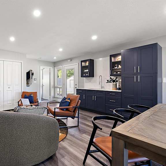 a living room with a kitchen and a table and chairs at sunnymede apartments - troy, mi, troy, 48084