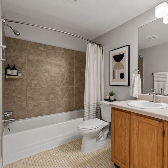 a bathroom with a toilet, sink, and bathtub.