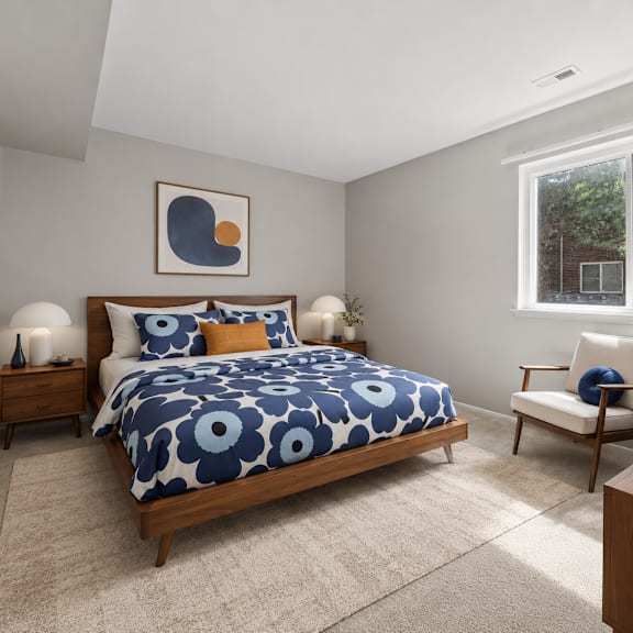 a bedroom with a bed, chair, and a painting on the wall.