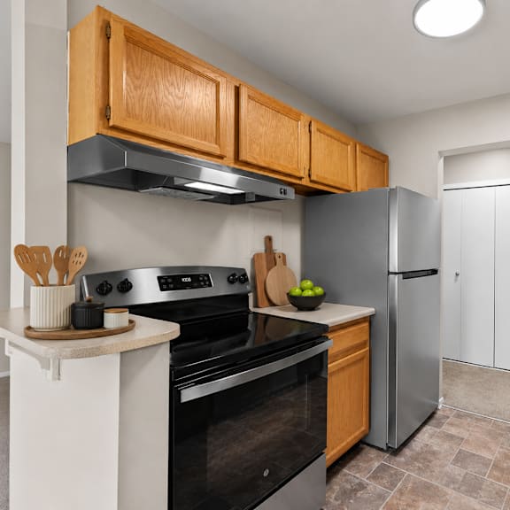 a kitchen with wooden cabinets and a black stove top oven.