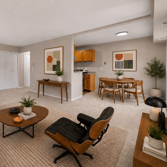a living room with a white couch, a coffee table, and a chair.