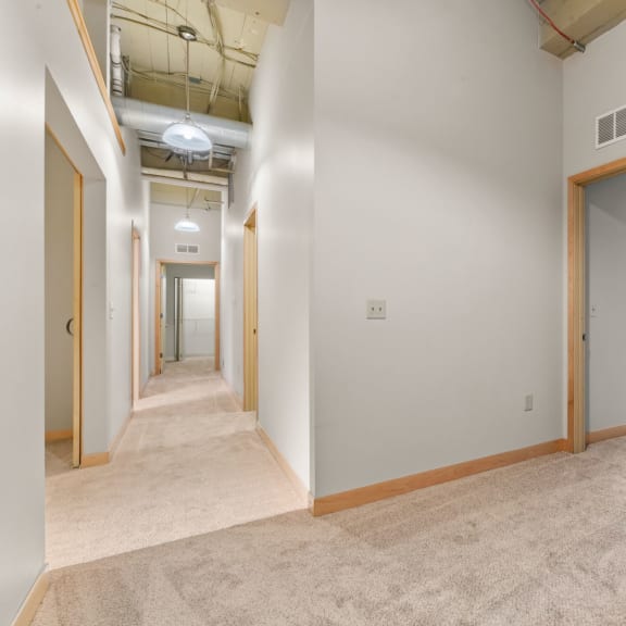 Thumbnail 7 of 13 Lower level hallway and staircase. Lowertown Lofts  in St. Paul, MN 3 Bedroom 2.5 Bath Plus Den Apartment  at Lowertown Lofts, Minnesota