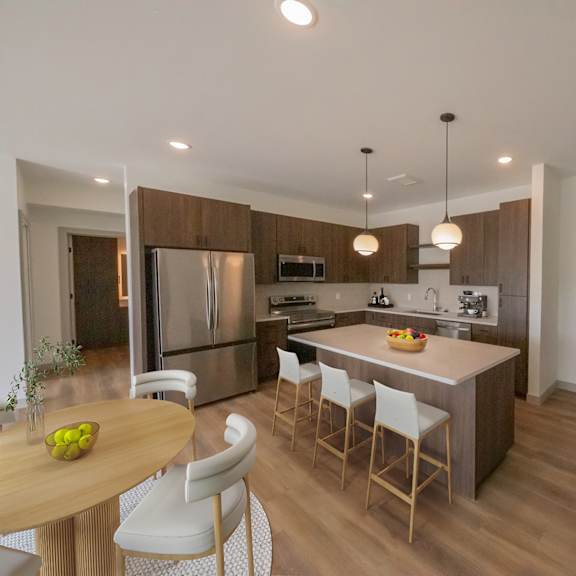 Thumbnail 4 of 10 Kitchen and dining area in the CC3 two bedroom plus den, two bathroom floor plan at The Mera in St. Louis Park, Minnesota