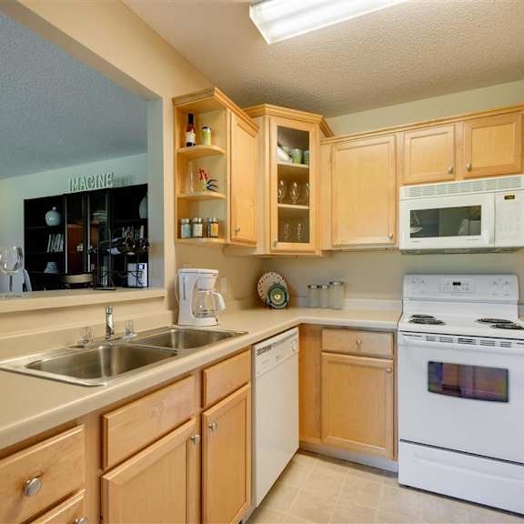 Thumbnail 5 of 7 Ridge floor plan - A kitchen with wooden cabinets and white appliances at Mallard Ridge, Maple Grove