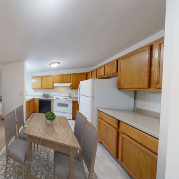 a kitchen with a table and chairs in the middle of the room.