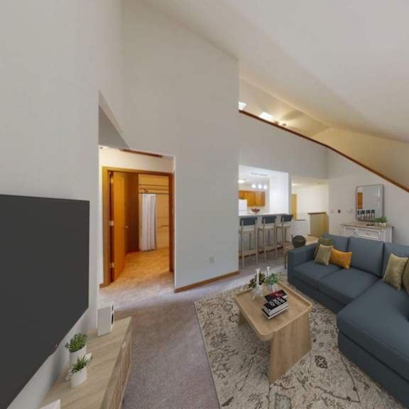 a living room with a grey couch and a wooden coffee table.